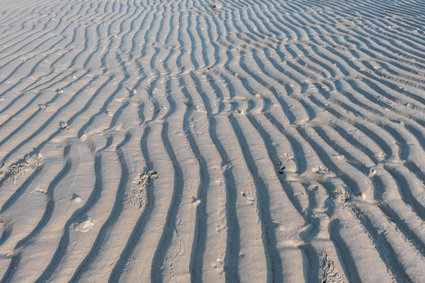 Low angle view of line pattern on sand created by waves in Belitung Island beach, Indonesia. Belitung is one of the most popular tourist destinations in Indonesia. photo