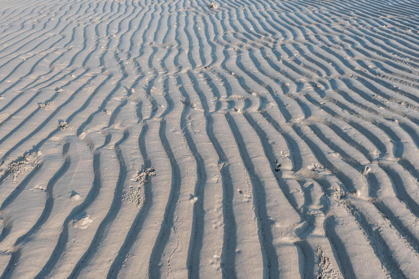 Low angle view of line pattern on sand created by waves in Belitung Island beach, Indonesia. Belitung is one of the most popular tourist destinations in Indonesia. photo