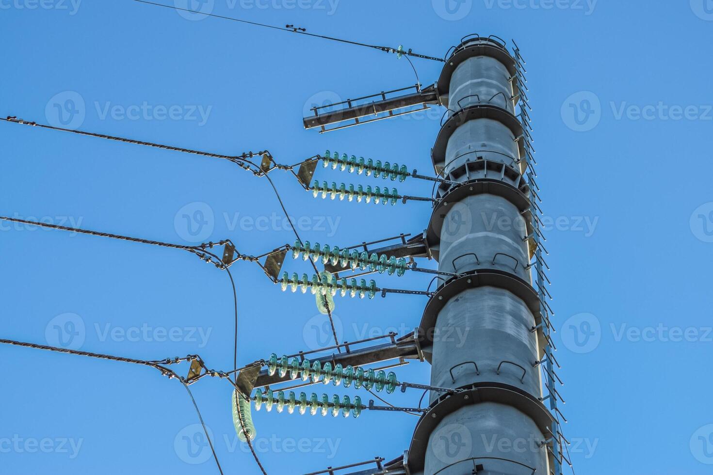 Supports high-voltage power lines against the blue sky photo
