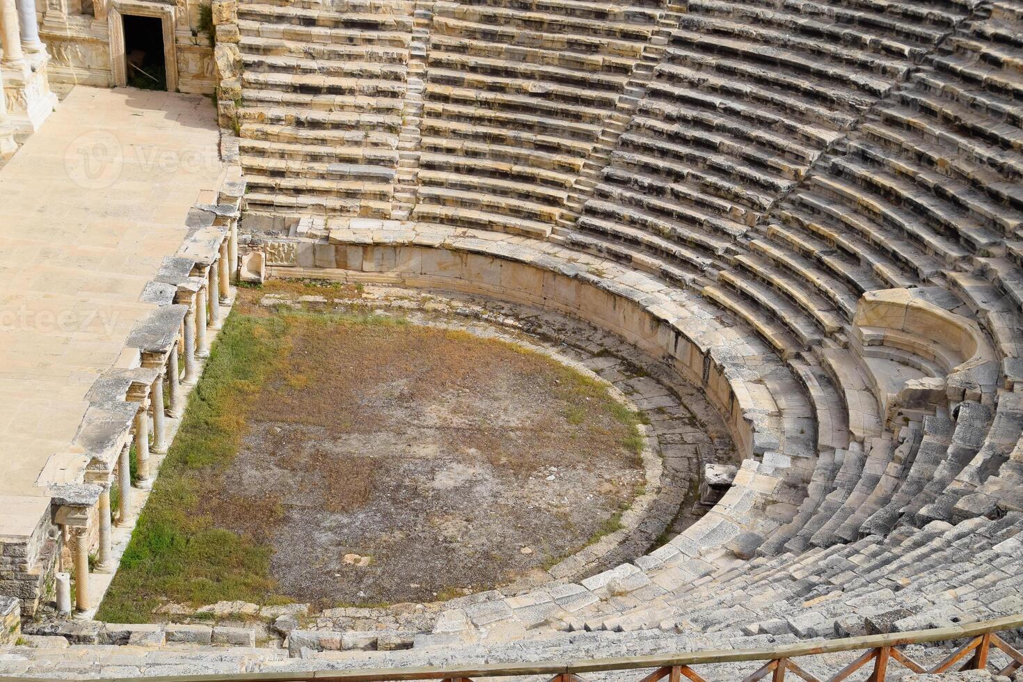 Ancient antique amphitheater in city of Hierapolis in Turkey. Steps and antique statues with columns in the amphitheater photo