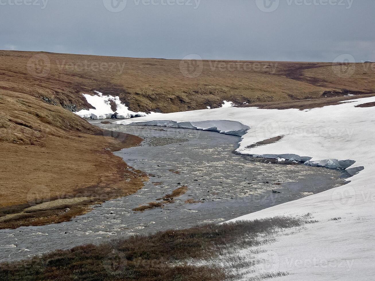 Melting snow in the spring. The spring heat will melt the snow. photo