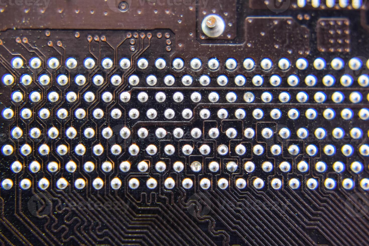 The reverse side of the microboard. Contacts solder. Soldered parts. Electronic board with electrical components. Electronics of computer equipment photo