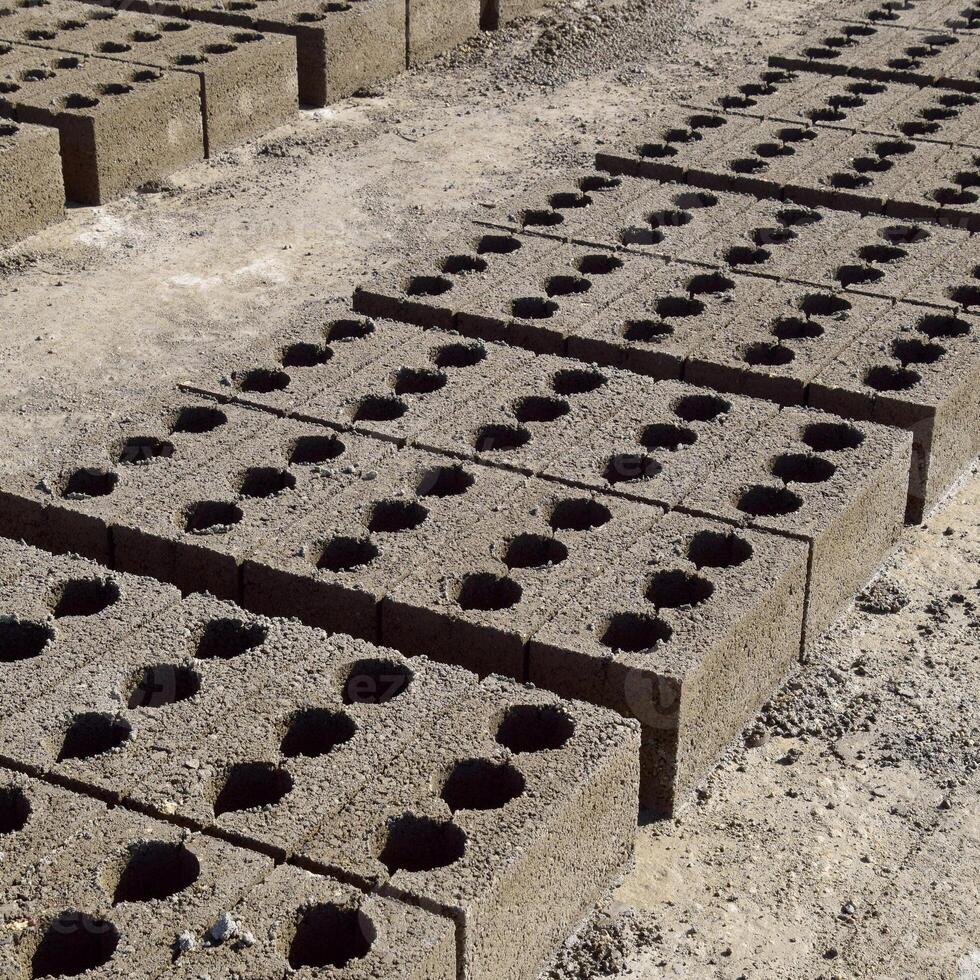 Cinder blocks lie on the ground and dried. on cinder block production plant. photo