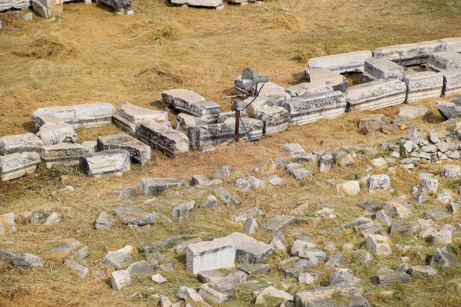 Top view of the excavation site in ruined ancient city of Hierapolis. The remains of destroyed buildings and columns. photo
