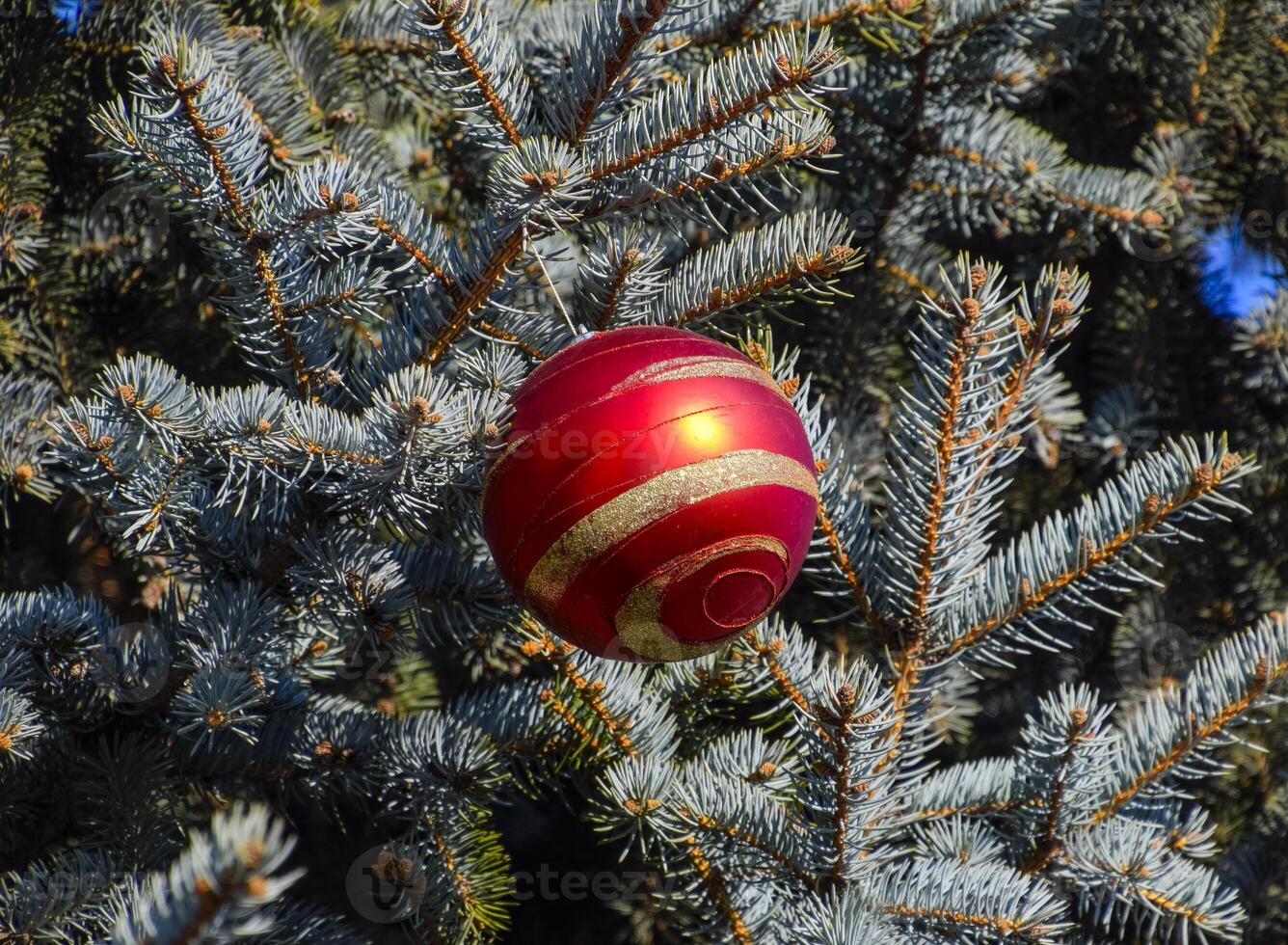 Decorations New Year tree. Tinsel and toys, balls and other decorations on the Christmas Christmas tree standing in the open air. photo