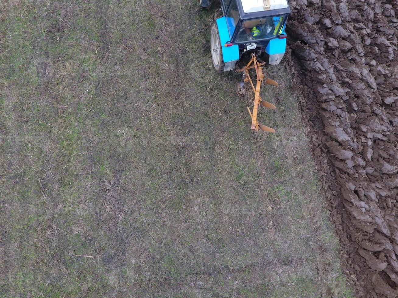 Tractor plowing the garden. Plowing the soil in the garden photo