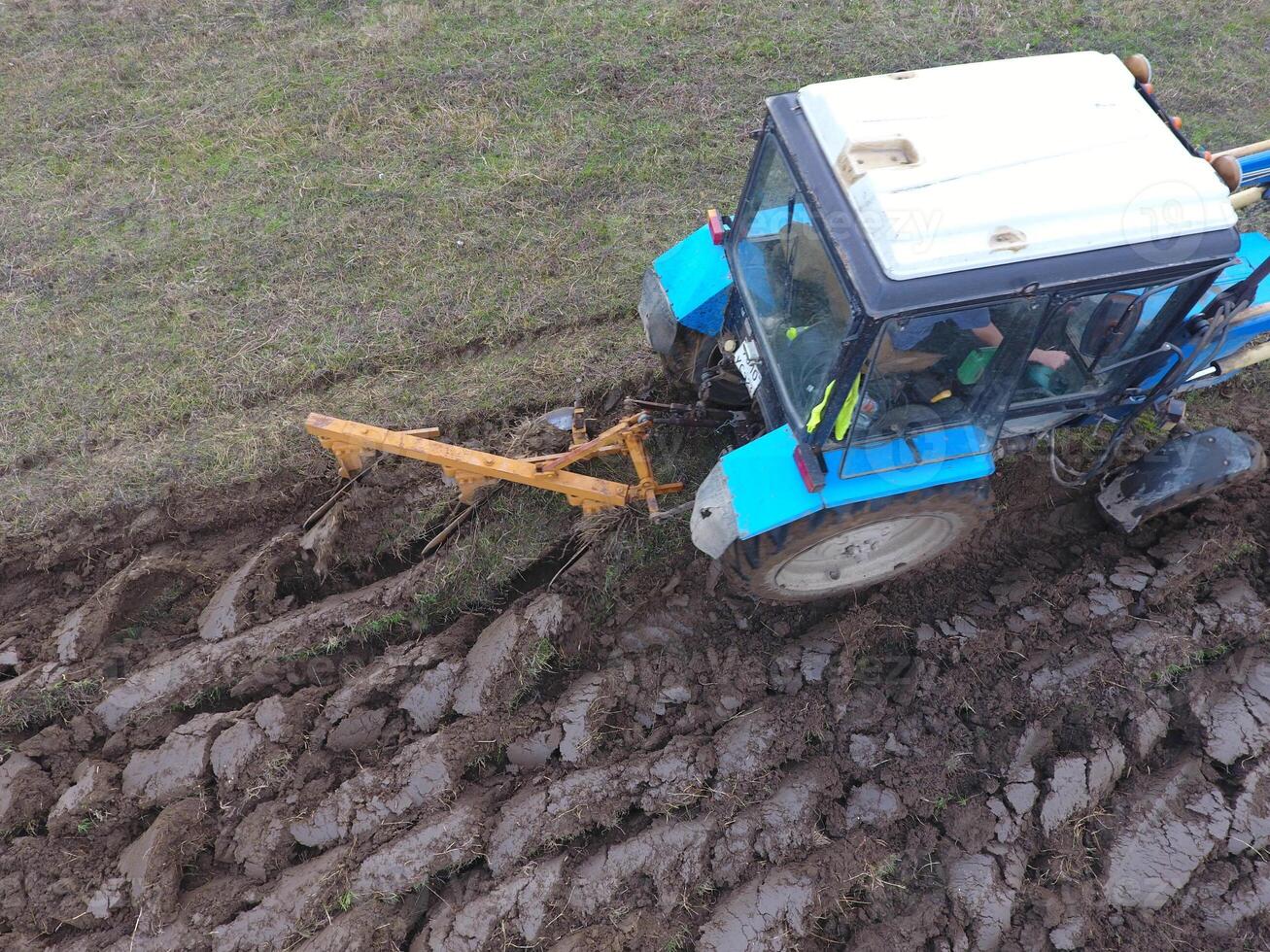Tractor plowing the garden. Plowing the soil in the garden photo
