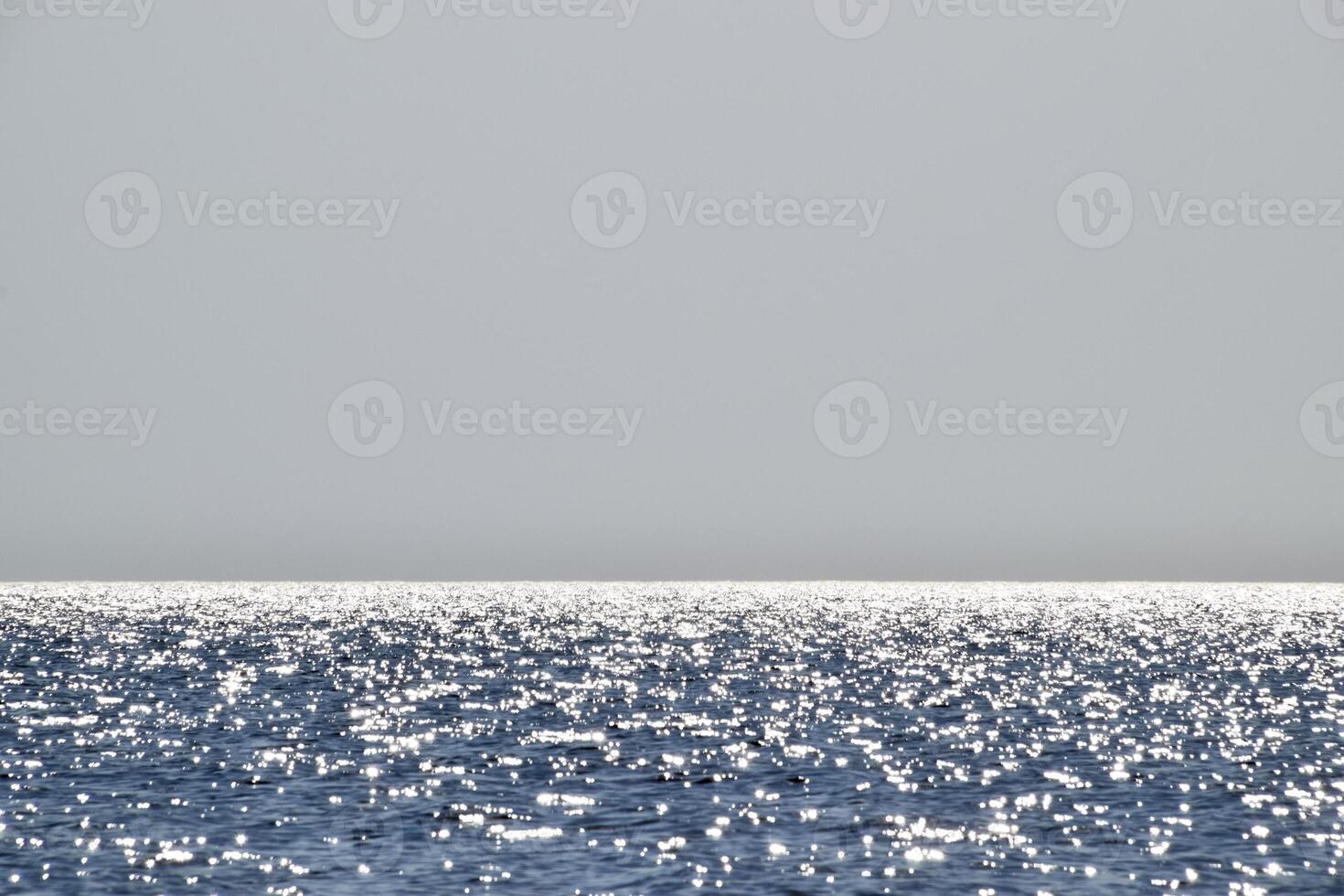 Sea line of the horizon. Sea and sky. The waves and glare of the sun are reflected from the waves of the sea. Seascape. photo