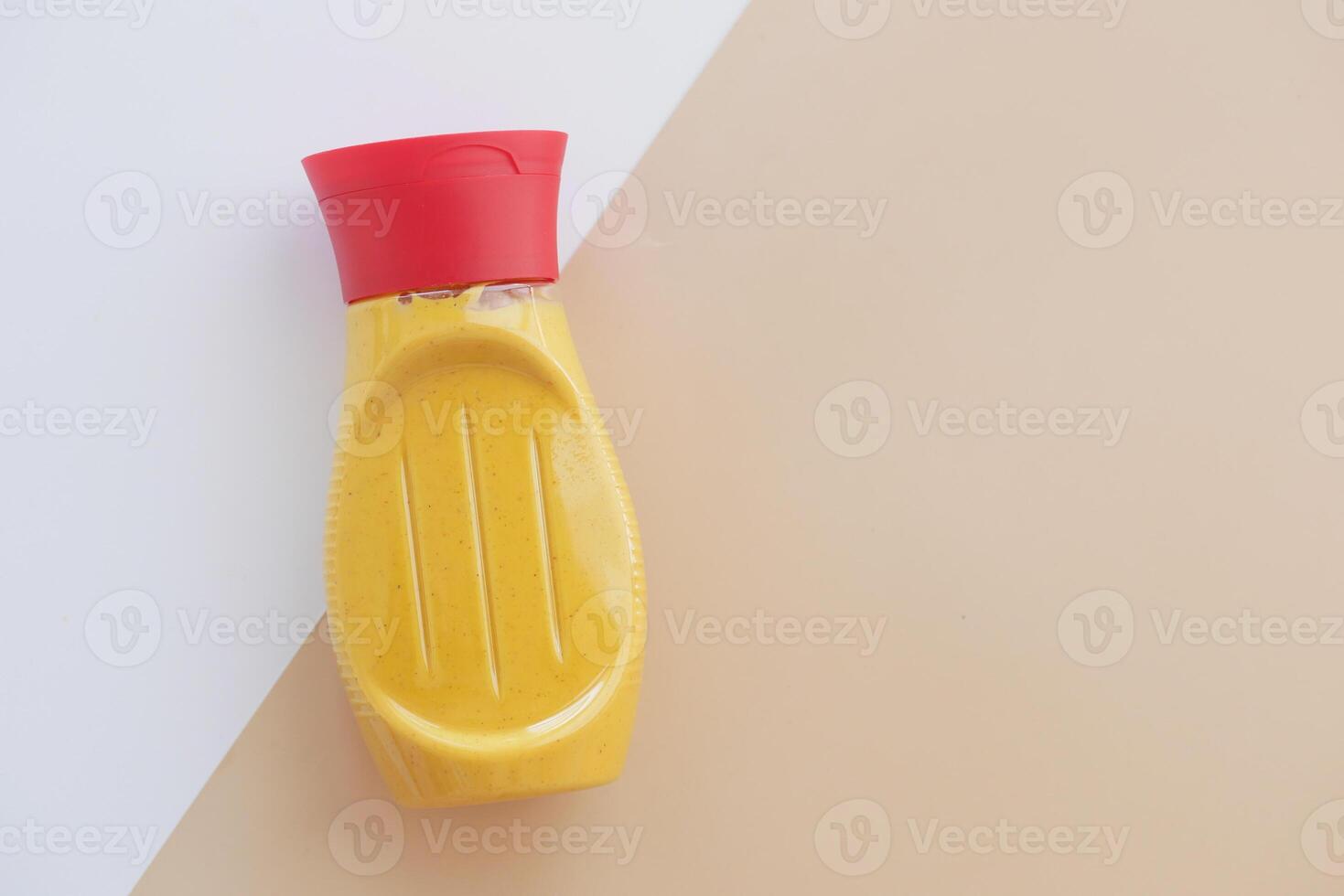 mustard mayonnaise in yellow container on color background photo