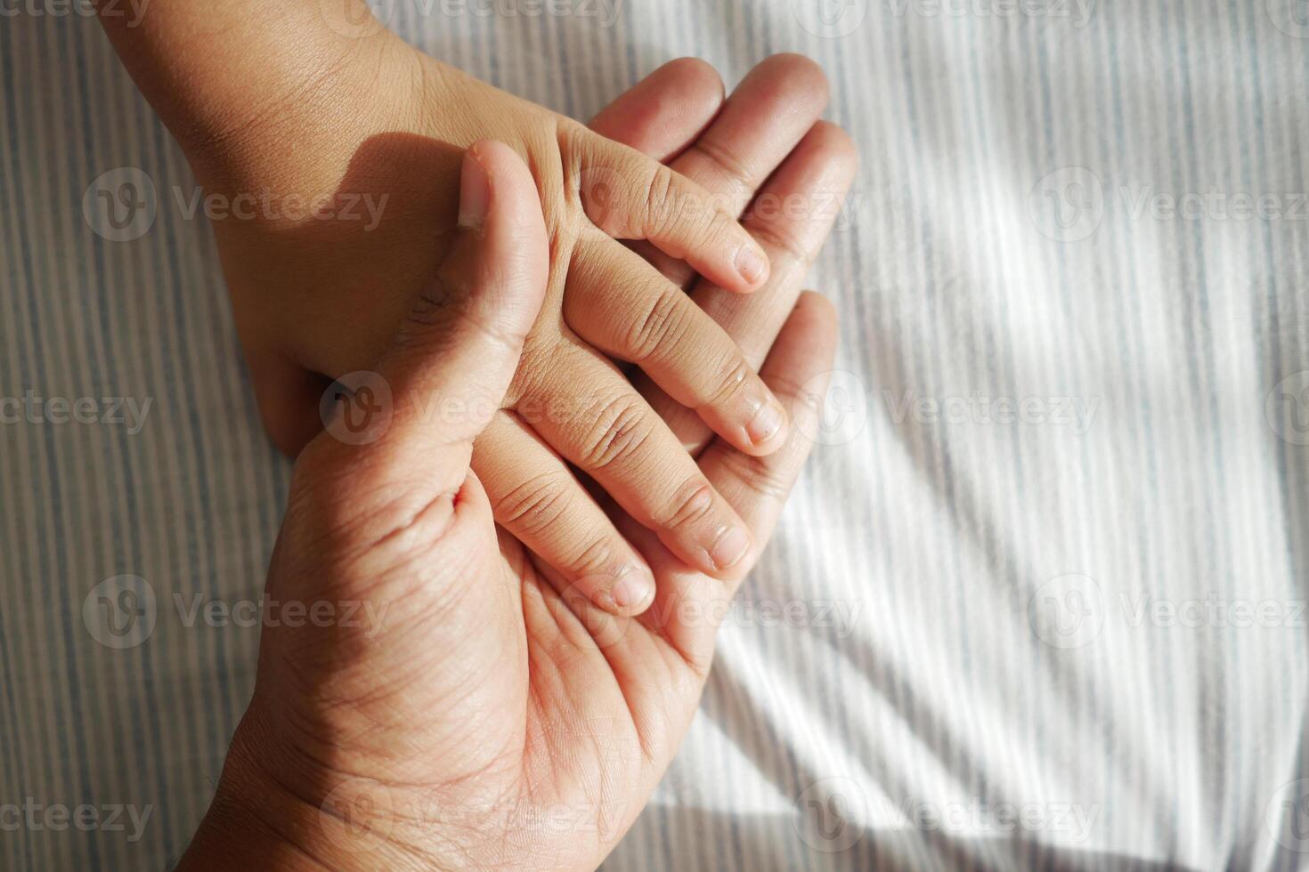 father holding hand of baby child, photo