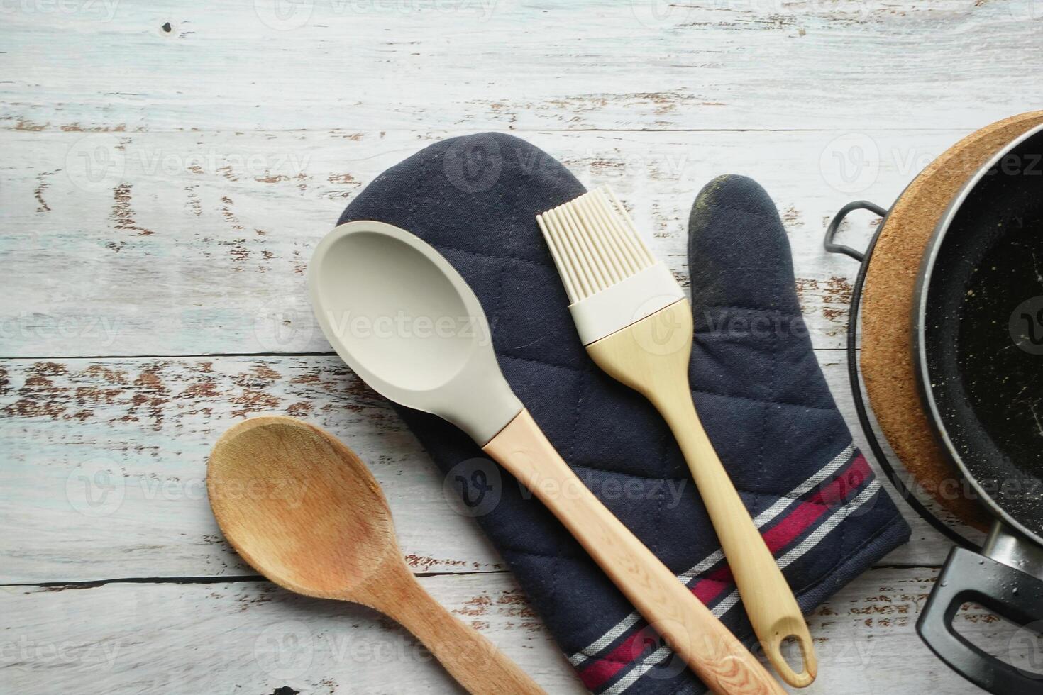 wooden cutlery fork and spoon and cooking pan on table photo