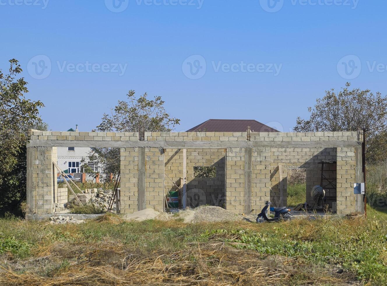 Unfinished house from a cinder block. The walls of the building under construction. photo