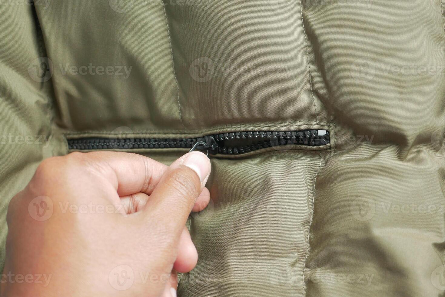 Man zipper on a jacket closeup photo