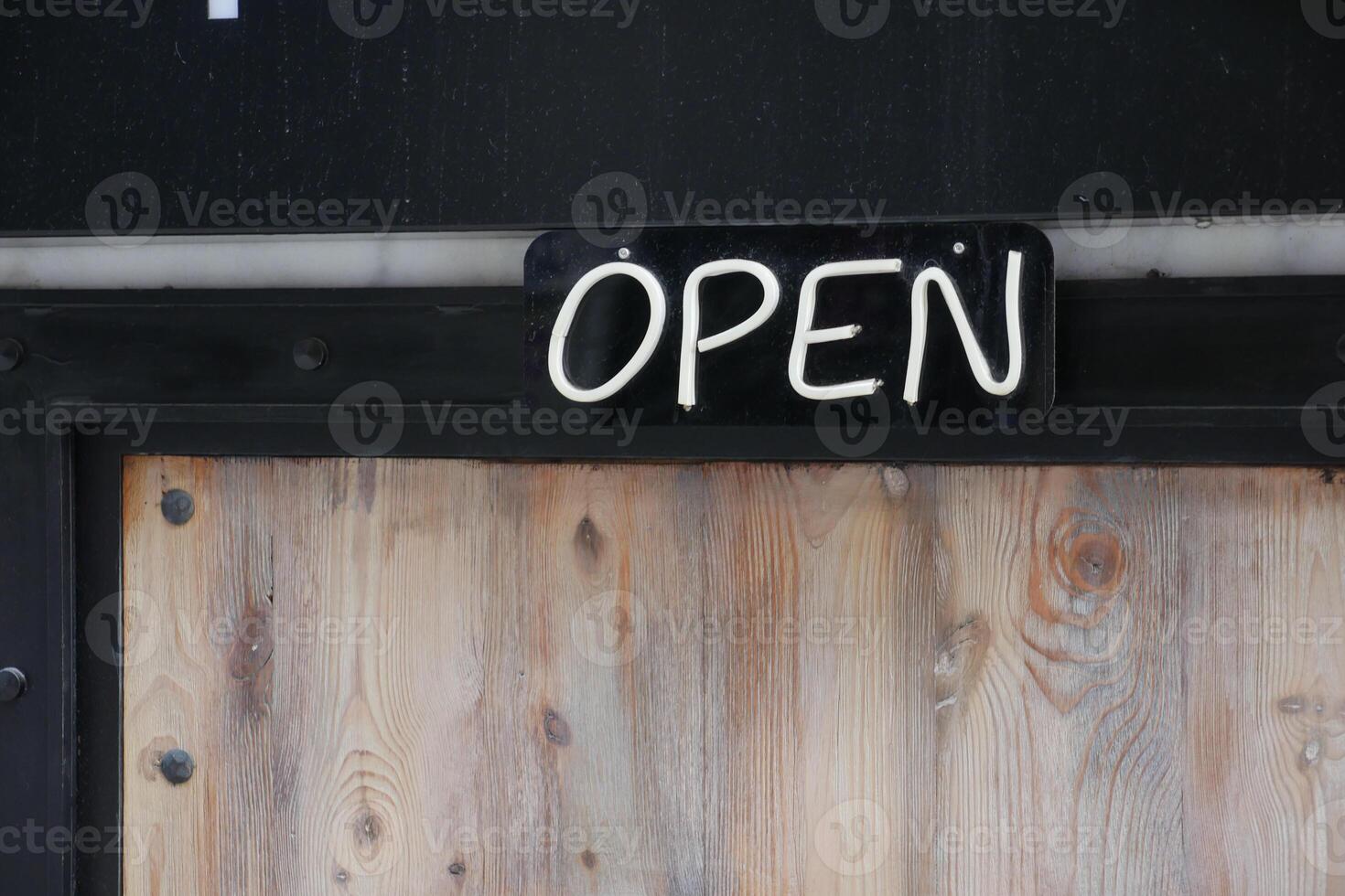 open text on paper hanging on cafe door photo