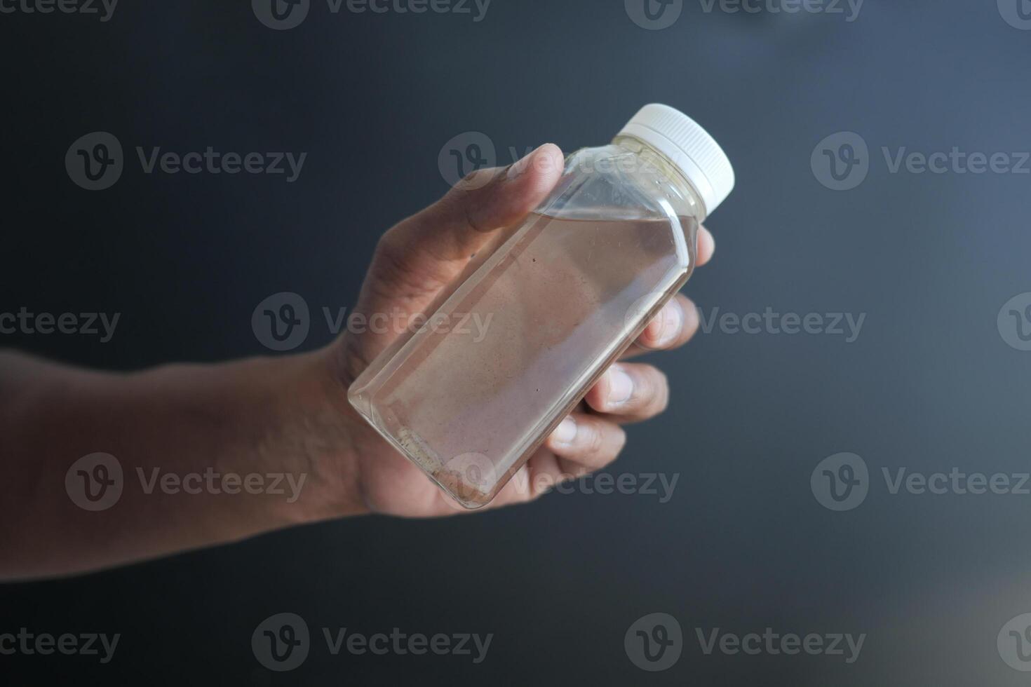 holding dirty bottle of water photo