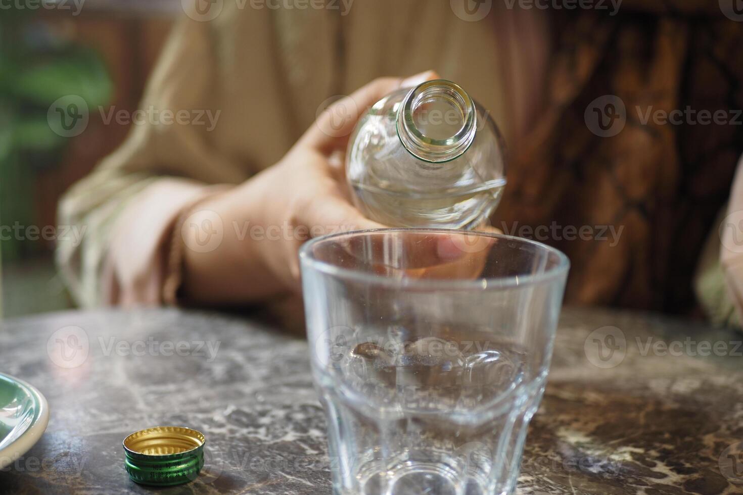 water pouring from a bottle into a glass photo