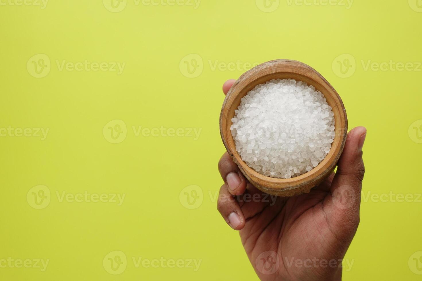 Salt crystals on yellow background photo