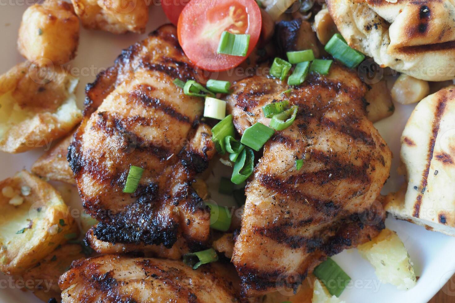 grill chicken meat served with salad on a plate photo