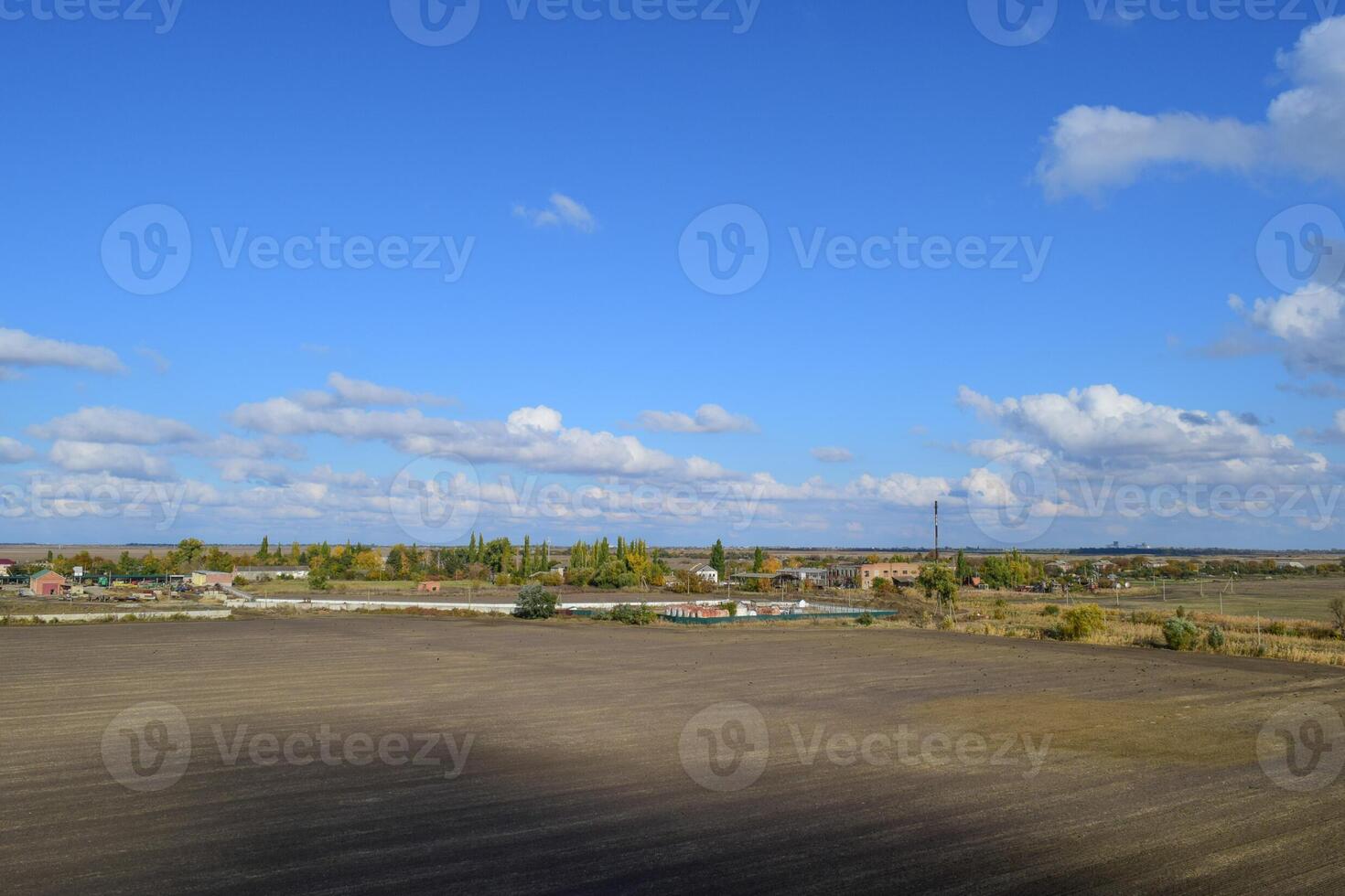 A view from above of a small Russian village. Rural landscape. Field and village. A semi-abandoned village. photo