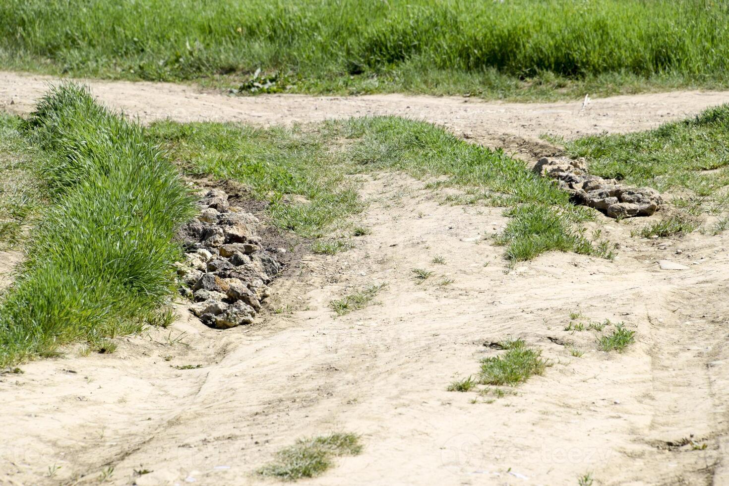 Pits on the road are filled with stones. Quarry stone. photo