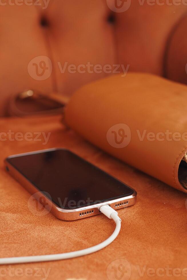 charging smart phone with a cable photo