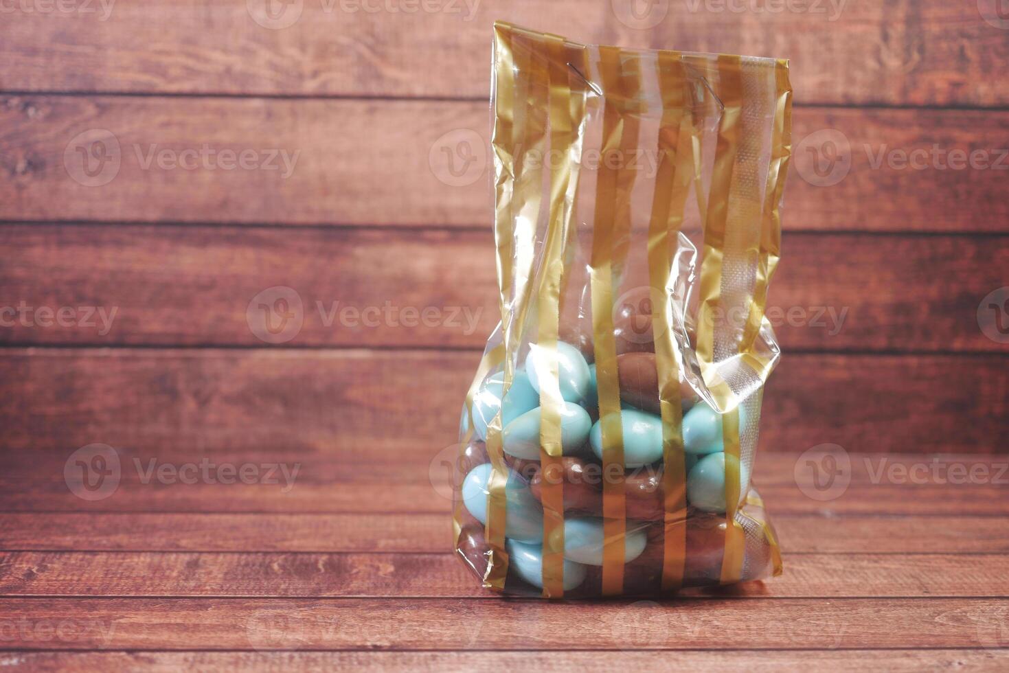 round shape chocolate candy in a plastic packet on table photo