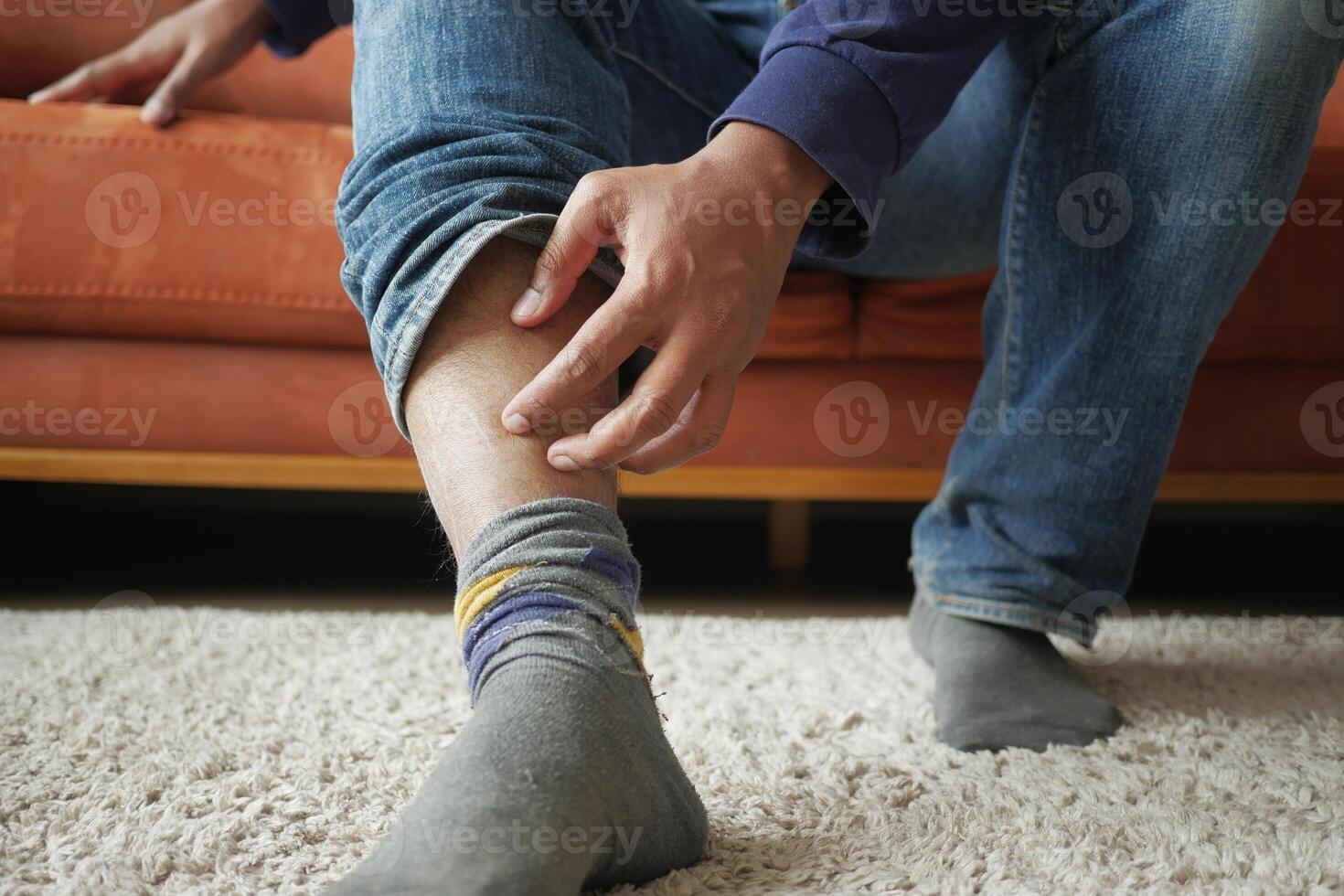 man suffering from itching skin on feet photo