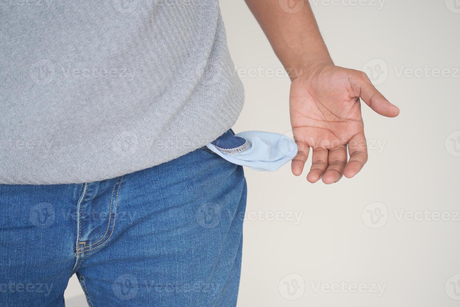 young man shows empty pant pocket with copy space photo