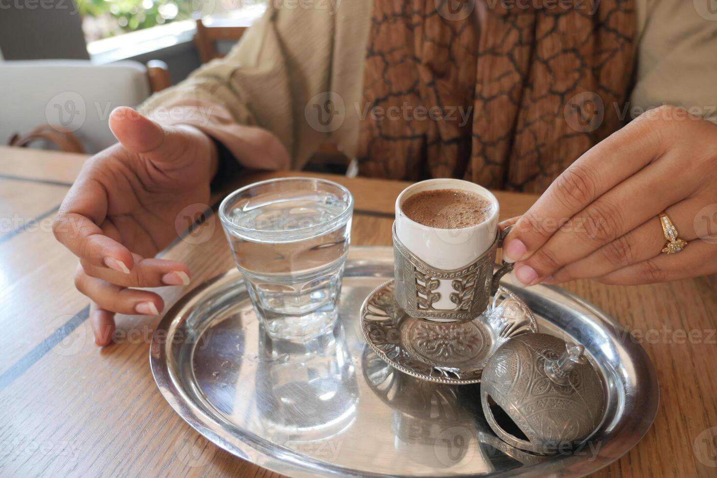 women drinking turkish coffee at cafe photo