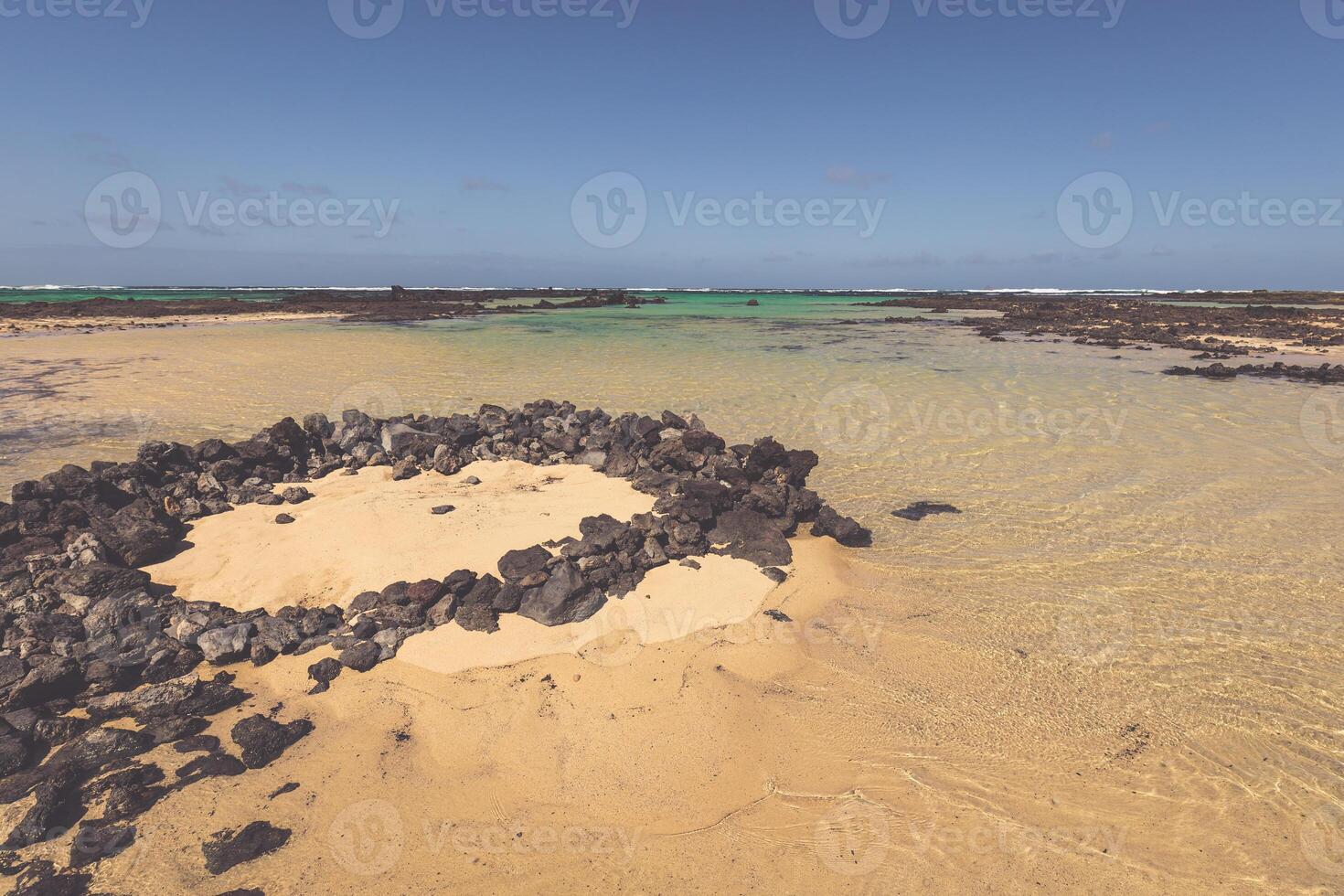 The coast of Atlantic ocean near town Orzola on Lanzarote, Canary islands, Spain photo