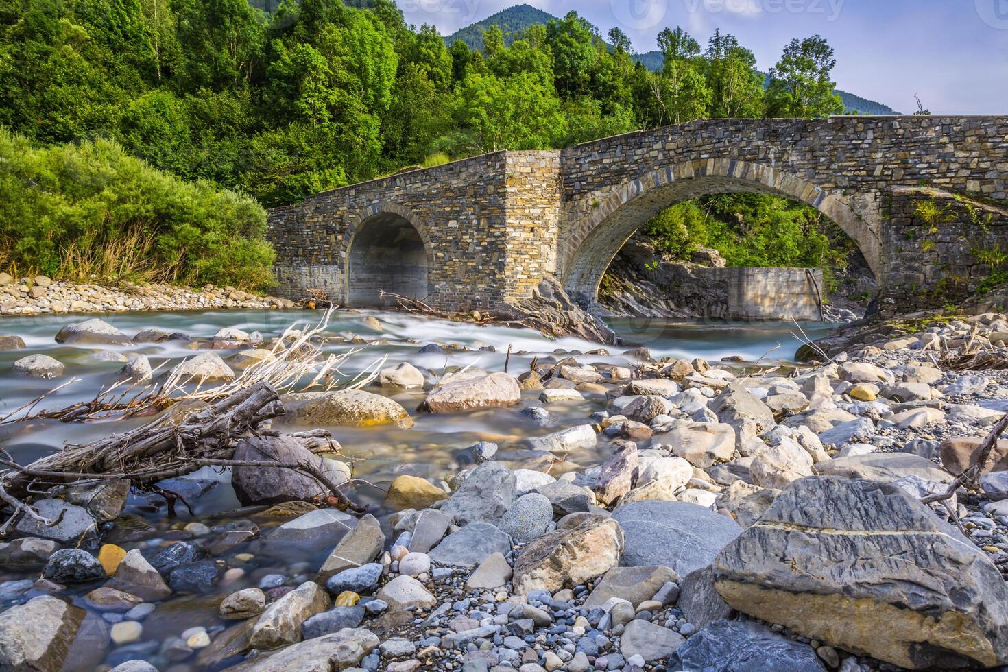 View of old stone bridge over river photo