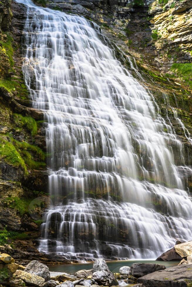 Cascada Cola de Caballo waterfall under Monte Perdido at Ordesa Valley Aragon Huesca Pyrenees of Spain photo