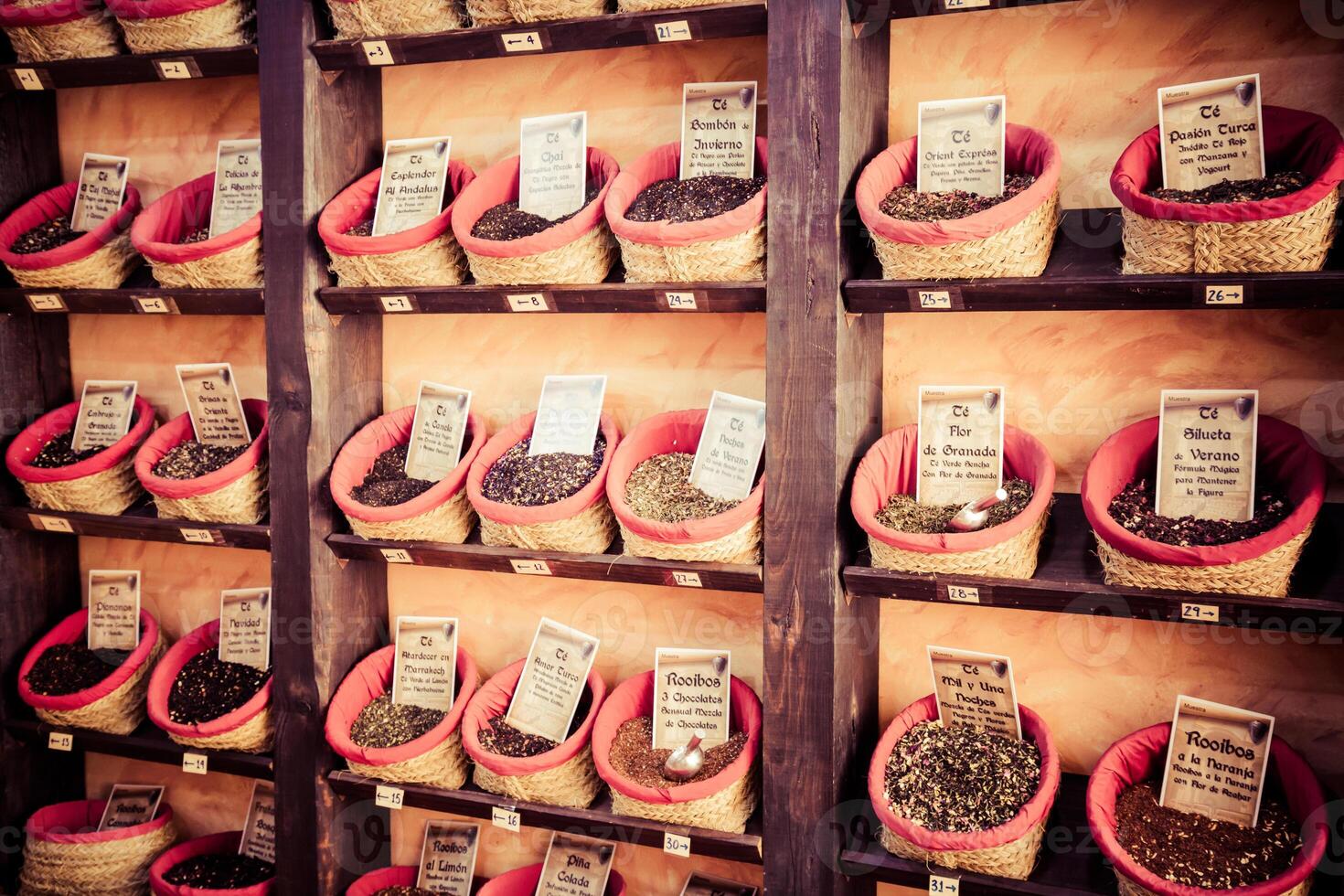 Spices, seeds and tea sold in a traditional market in Granada, Spain photo