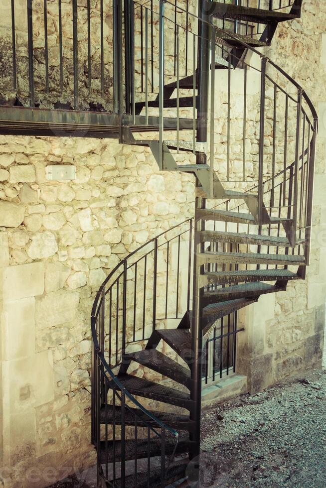 Very old outdoor spiral staircase photo