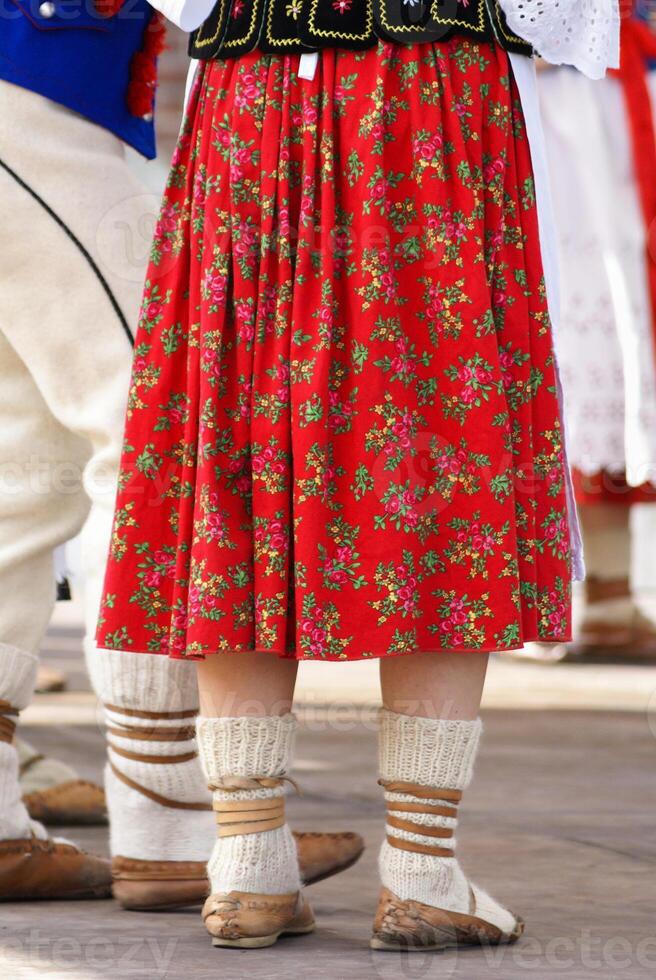 Horizontal colour image of female polish dancers in traditional folklore costumes on stage photo