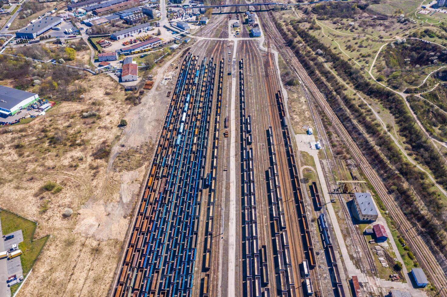 Cargo trains. Aerial view of colorful freight trains on the railway station. Wagons with goods on railroad.Aerial view photo