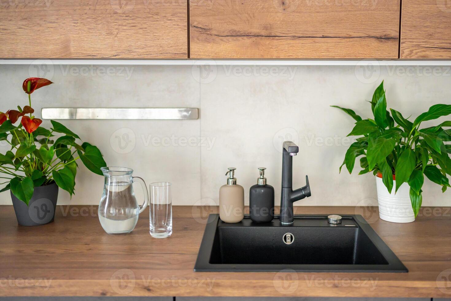 Jug with clear cold water on kitchen table in the home photo
