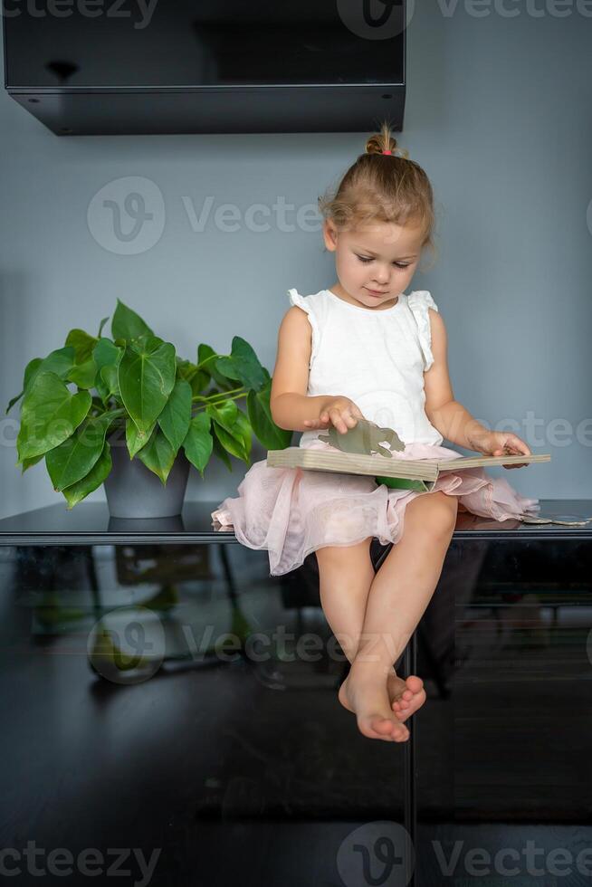 Adorable toddler little girl reading book at home. Happiness child reading book for preschool enjoy with learning education by yourself. Education concept photo