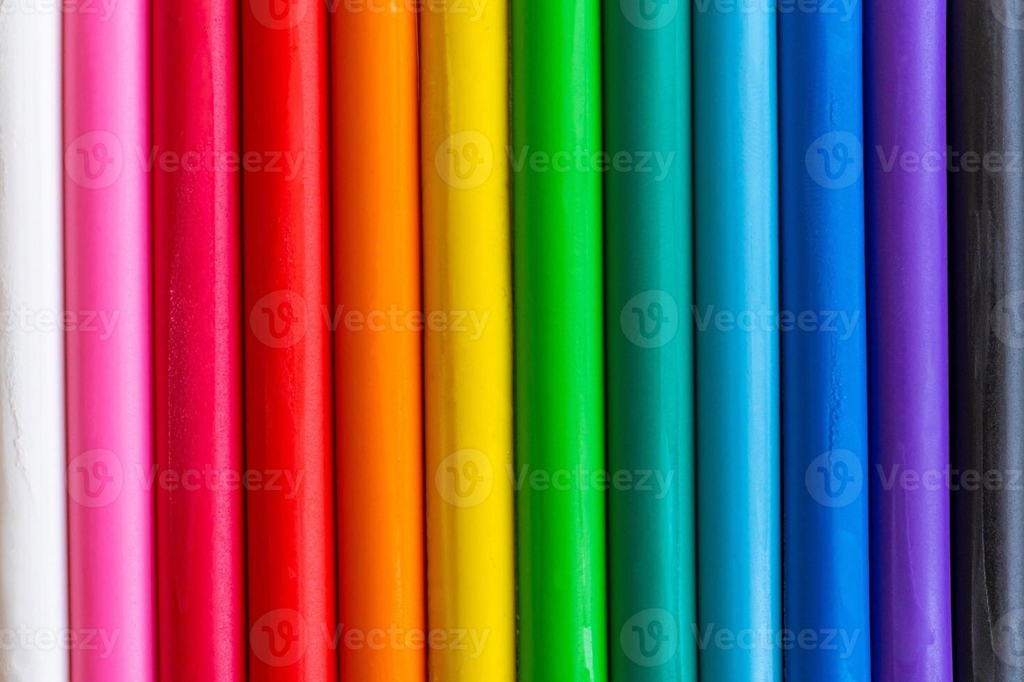 Multicolored pieces of plasticine are arranged vertically as a background. photo