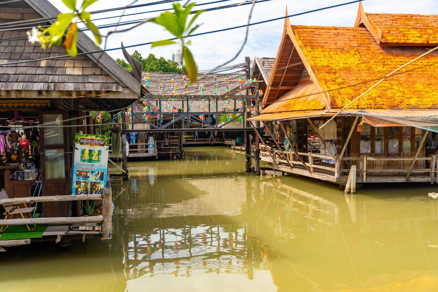 Pattaya, Thailand - December 29, 2023. Floating open air market with small houses - shops on the pond in Pattaya, Thailand. High quality photo