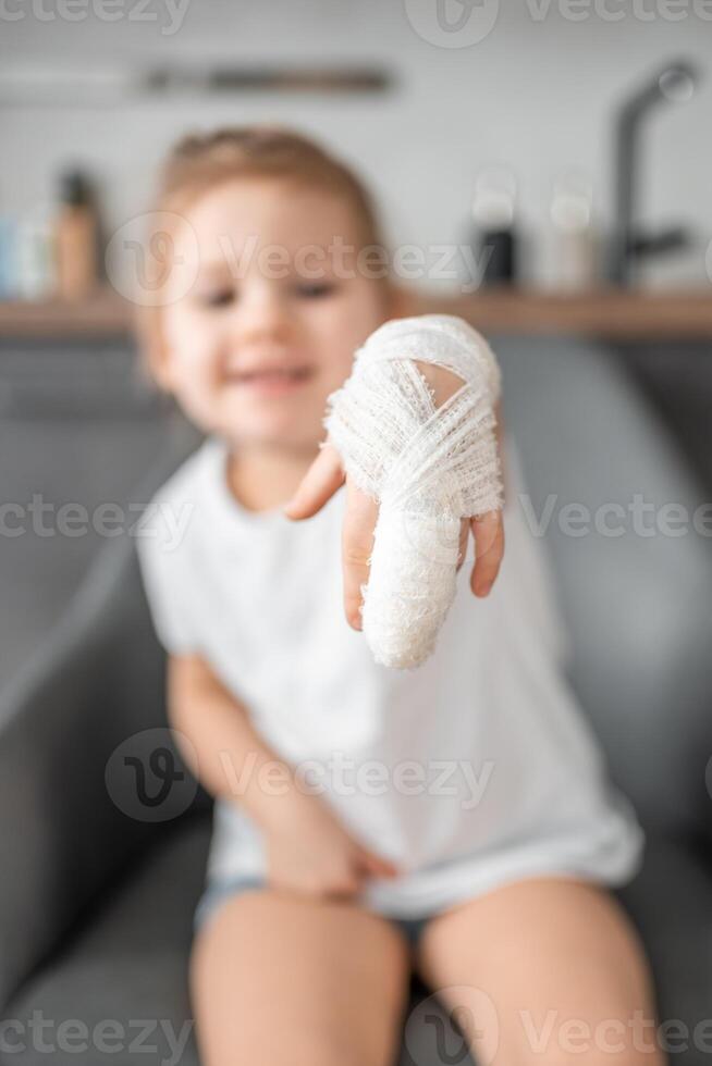 Little girl with broken finger at the doctor's appointment in the hospital photo