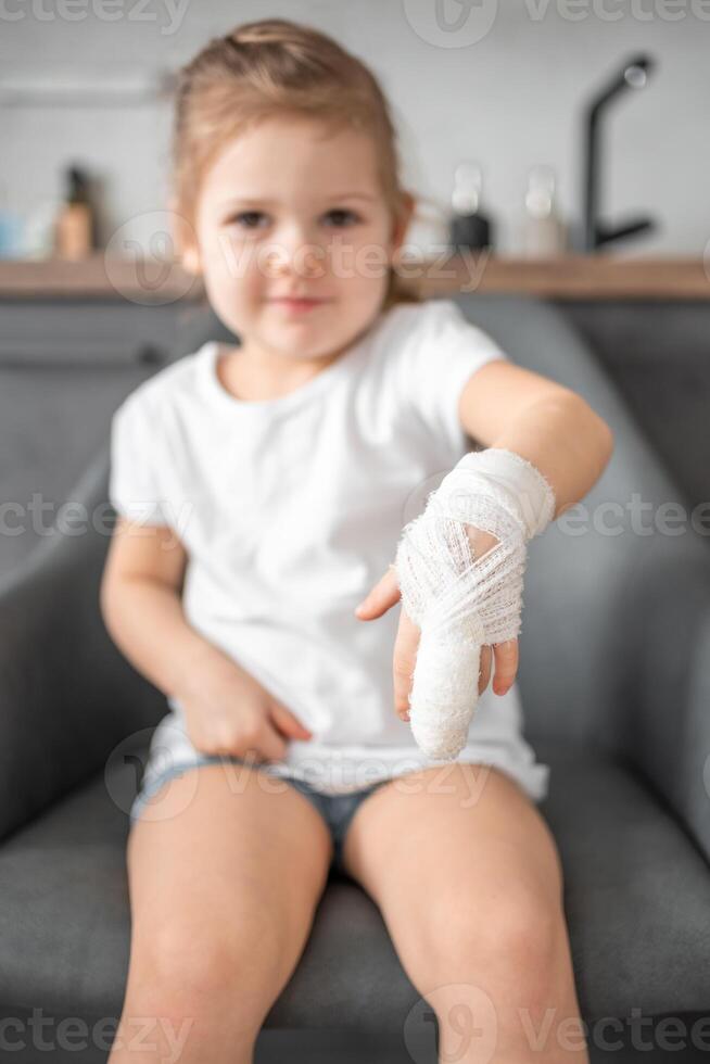 Little girl with broken finger at the doctor's appointment in the hospital photo