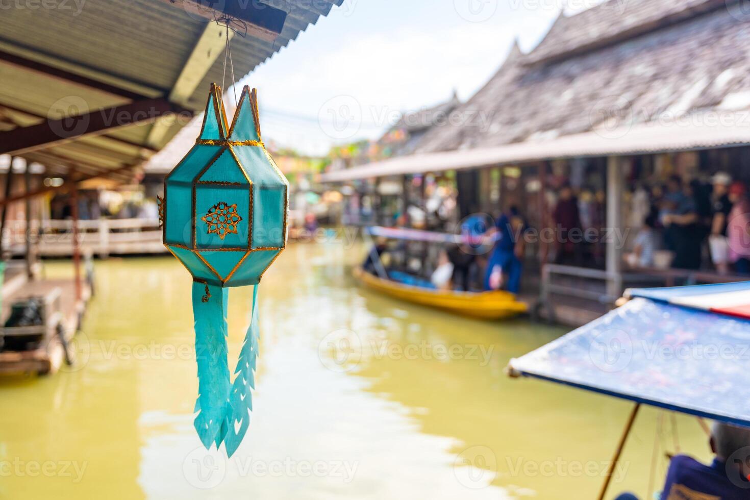 Green lantern in floating open air market with small houses - shops on the pond in Pattaya, Thailand. High quality photo