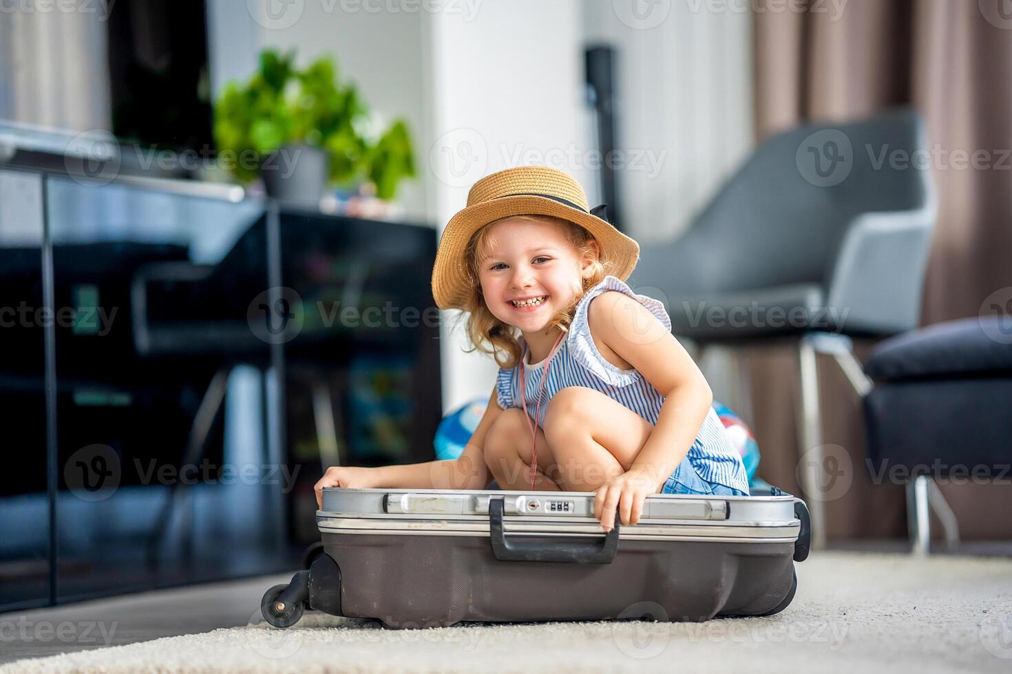 Little girl in suitcase baggage luggage ready to go for traveling on vacation photo