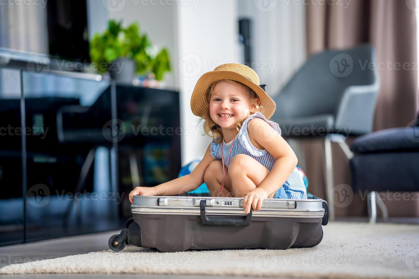 Little girl in suitcase baggage luggage ready to go for traveling on vacation photo