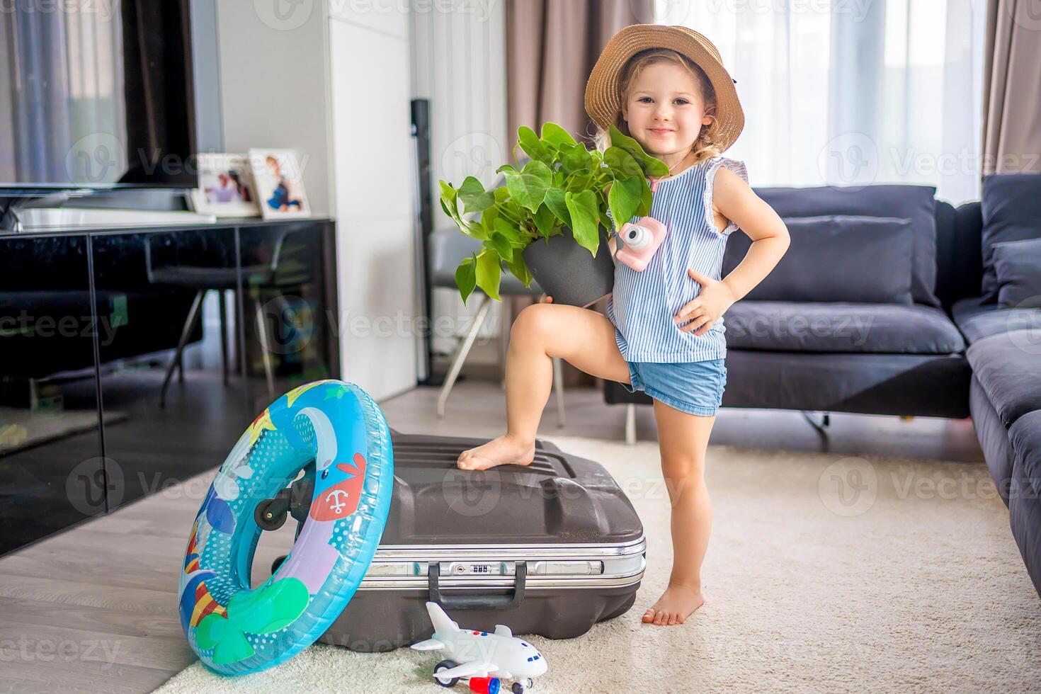 Little girl with suitcase baggage luggage ready to go for traveling on vacation photo