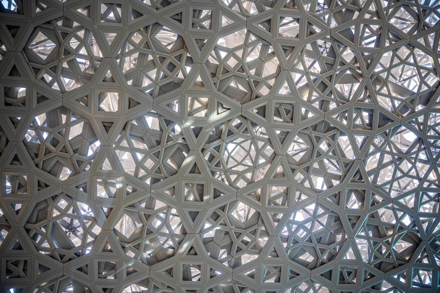 Abu Dhabi, UAE - December 6, 2023. Interior of Louvre, Dome in the form of branches over the museum buildings in Abu Dhabi, UAE photo