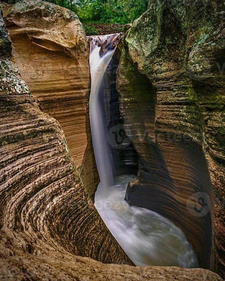 Beautiful view of the waterfall between the cliffs photo