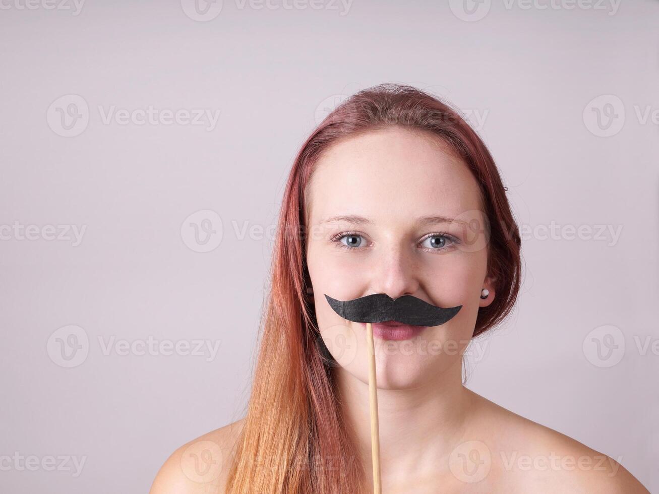 young woman with fake moustache photo