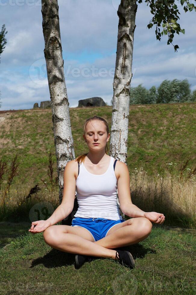 young woman in lotus pose photo